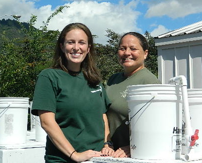 Image of Danielle and Leina'ala with their aquaponic system setup.